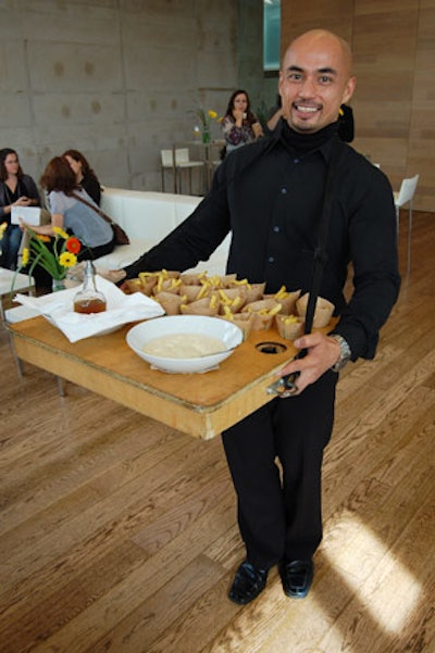 Servers offered passed hors d'oeuvres like smoked turkey breast with cranberry compote on sage gougères and cones filled with Jamie Kennedy's French fries.