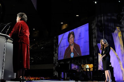 Helen Devore Waukazoo accepted a Minerva award on a stage flanked with illuminated set pieces in a fin-inspired motif.