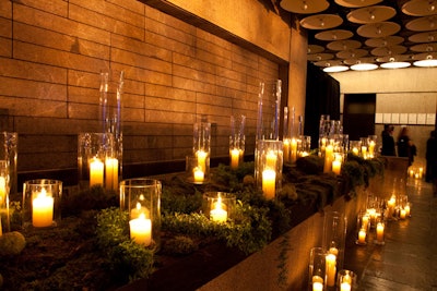 Hundreds of candles and lots of moss accented the museum's entrance and press wall.