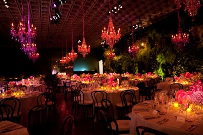 Pink and purple crystal chandeliers hung above the gala dinner's round tables.