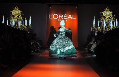 Soprano Ambur Braid kicked off the L'Oréal Paris retrospective with a performance on the runway.