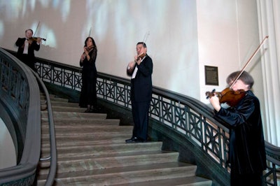 As guests arrived, violinists positioned on the museum's main stairwell played classics such as 'On the Street Where You Live.'