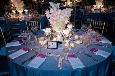 Heffernan Morgan's centerpieces incorporated tiered vessels, mirror boxes, and blush cymbidium orchids, all on top of BBJ's grey bengaline linens