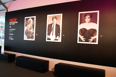 Four photographs from the Royal Ontario Museum's 'Vanity Fair Portraits' exhibit are displayed on a wall in the Fashion Environment.