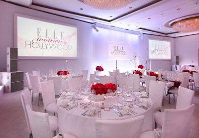 The ballroom was predominately white, with splashes of burgundy in the form of dahlias; white-framed screens showed honoree reels.