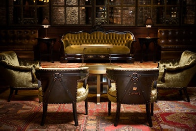 Dark wood, upholstered furnishings, and rich patterned carpeting deck Voyeur.