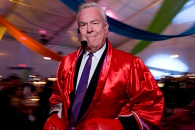 Bill Kurtis conducted part of the live auction in a red boxer's robe.