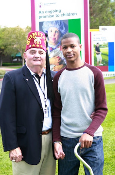 Gary Dunwoody, a member of the Shriners board of trustees and chairman of the Justin Timberlake Shriners Hospitals for Children Open, posed with LaQuan Phillips, a Las Vegas patient treated by Shriners.