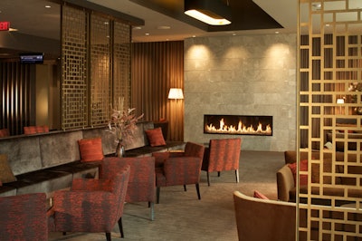 The cinema houses a lounge area with a bar, a fireplace, and banquette seating.