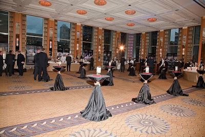 In the ballroom of the Peninsula Chicago, candles and crushed rose petals topped highboy tables.