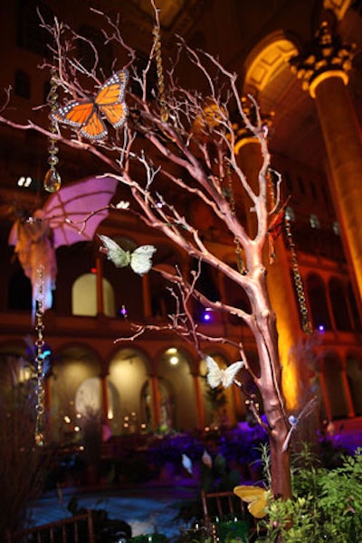 Fabric butterflies and strings of crystals dangled from branches placed on tabletops as centerpieces.