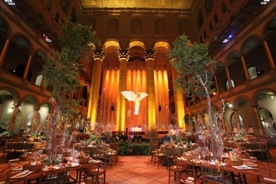 Living tree centerpieces and a fairy suspended from the ceiling of the National Building Museum evoked an enchanted forest.