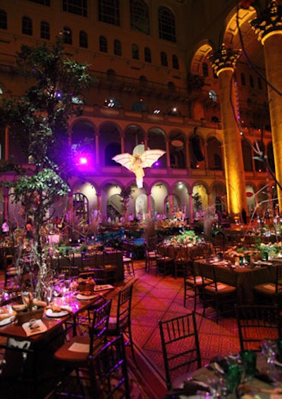 The dining room's decor included earthy green and brown table linens, living herb centerpieces, and twig-shaped forks.