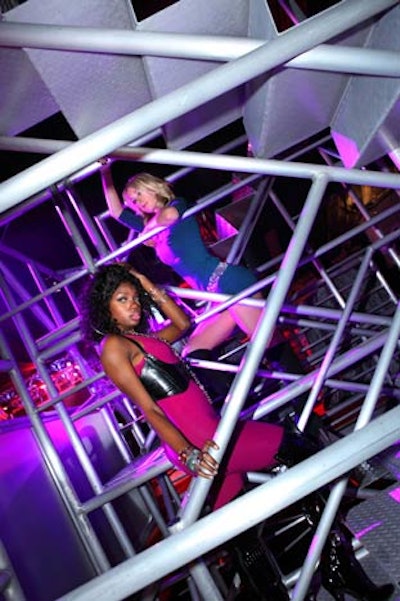 Performers danced on multiple levels within truss structures throughout the party space.