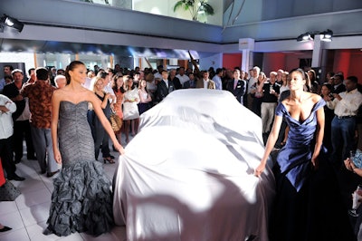 Models in Rene Ruiz couture dresses unveiled the Porsche Panameras at the showroom.