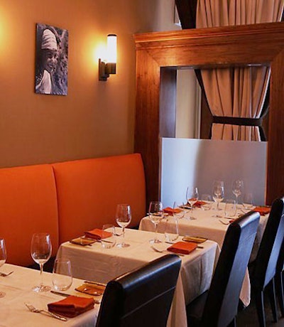 Orange hues and black-and-white photographs spruce up the space.