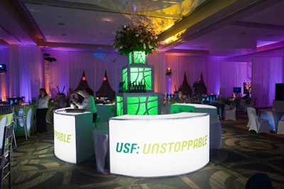 Showorks Inc. branded the illuminated bars from Room Service Furniture and Event Rentals with the fund-raising campaign's name, 'USF: Unstoppable. '