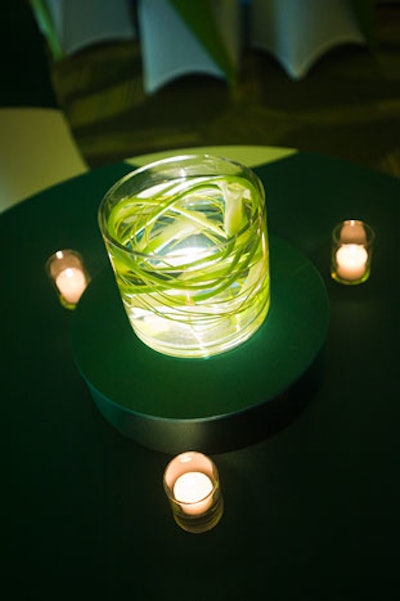 Simple green leaf centerpieces accented with tea lights topped the tables in the ballroom.