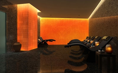 A salt meditation room has a wall of illuminated salt bricks meant to encourage healing and respiration.