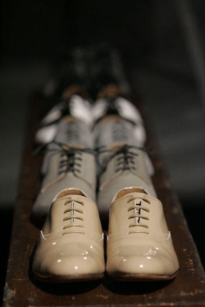 Organizers lined up Generic Man's shoes along wooden planks.