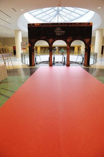 A red carpet and archway sat at the top of the escalators.