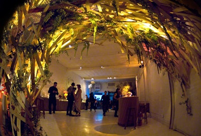The entrance to the event was marked with a large curving structure made from recycled wooden beams and designed to match the night's 'nature's revenge ' motif.