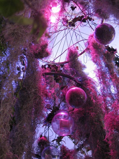 In the garden area, Reverdy created chandeliers using old bicycle wheels, Spanish moss, stained baubles, and wire.