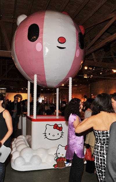 A kitschy hot air balloon toy moves up and down by way of controls inside; guests at the party played inside the gadget all evening long.