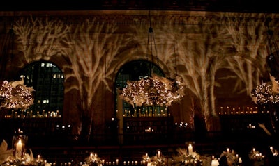 Lighting on the walls of the venue simulated shadows cast by branches.
