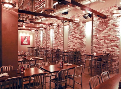 The space has an industrial look, with exposed brick and beams.