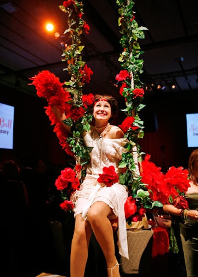 A performer seated on a swing greeted guests in the dining room.