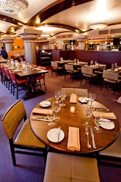 Large communal tables and smaller square tables, rounds, and high-back booths provide seating.