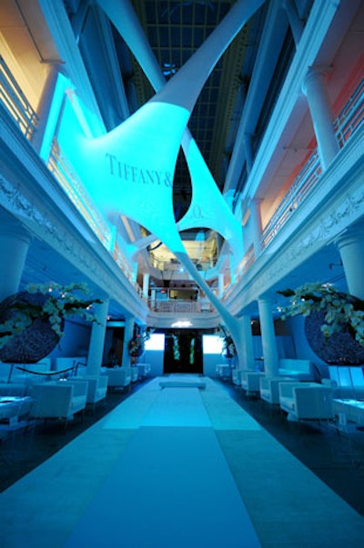 3B Productions projected sponsor logos and music videos on the two side panels of the runway backdrop and the building's atrium sculpture.