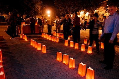 Event producer Eddie Diaz of Encore Creations used the paper bags at each place setting where guests wrote what they were thankful for to create a luminaria display outside for the dessert service.