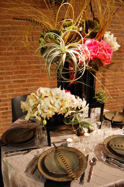 Blade Floral and Event Designs went for a lush, natural look with air plants, feathers, ruffled peonies, and a textured tablecloth.