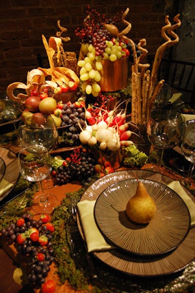 The winning design, by Neuman's, had an earthy fall harvest look with a bounty of fresh produce, moss, wooden chargers, and linens in autumnal hues.