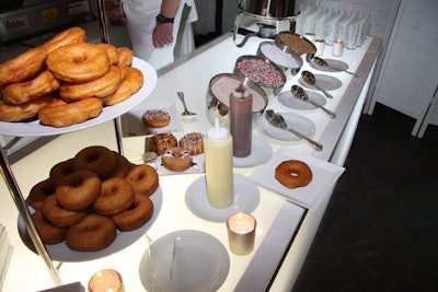 At the doughnut station, guests could top freshly baked plain doughnuts with white or milk chocolate sauce, powdered sugar, chopped nuts, or colored sprinkles.
