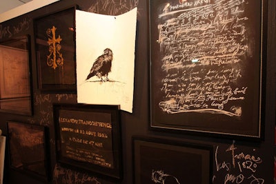 Chalkboard walls and charcoal drawings of crows surrounded artist Francine Turk's table.