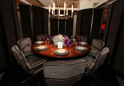 Also filled with dark hues, the table from Herman Miller by Richard Bliss and Solomon Cordwell Buenz incorporated purple Hermes cocktail glasses.