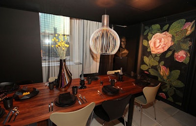 Black plates and dark, lacy napkins topped the table that fashion designer Maria Pinto designed with Scott A. Heuvelhorst Interiors.