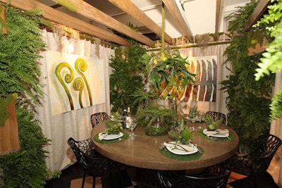 Ferns, a leafy chandelier, and grassy place mats created a garden-like setting for Soucie Horner Ltd.'s table.