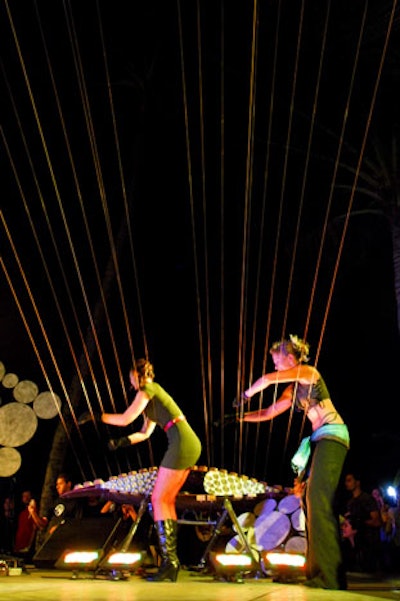 Members of the art and performance troupe Mass Ensemble played a giant harp whose strings spanned Ocean Drive to the top of the Park Central Hotel.