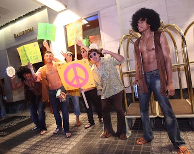 Male models played the role of hippie protesters at the Knock Out Abuse gala, adding a playful interactive element.
