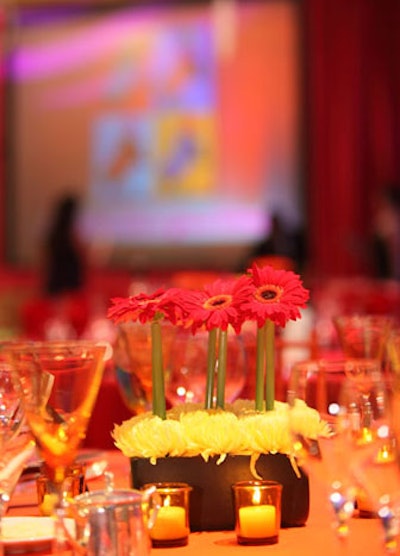 To fit the flower-power, '60s theme at Knock Out Abuse, table centerpieces included brightly colored gerbera daisies