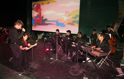 The SoBe Arts Chamber Ensemble and Jazz Ensemble performed in collaboration with cartoons projected on a large screen behind them on the Ocean Drive Main Stage for the Tunes N Toons event.