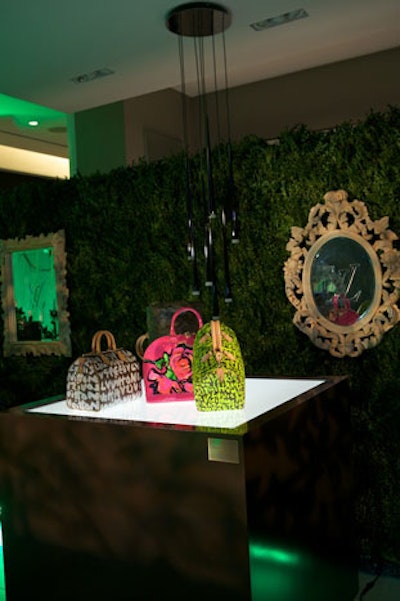 The launch also served as a showcase for Louis Vuitton's past collections, including Stephen Sprouse designs. Behind these exhibits, boxwood hedges—the largest stood 20 feet long and eight feet tall—held hand-carved birch mirrors.