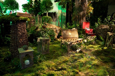 To create a forest scene to display some of the label's collection, David Beahm used five kinds of mosses, built life-sized trees using branches wound around metal frames, and decorated the area with other leafy plants.