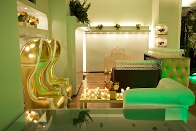 Metallic gold chairs, tufted bars, and mirror-topped tables served as a foil to the abundant flora spread throughout the space.