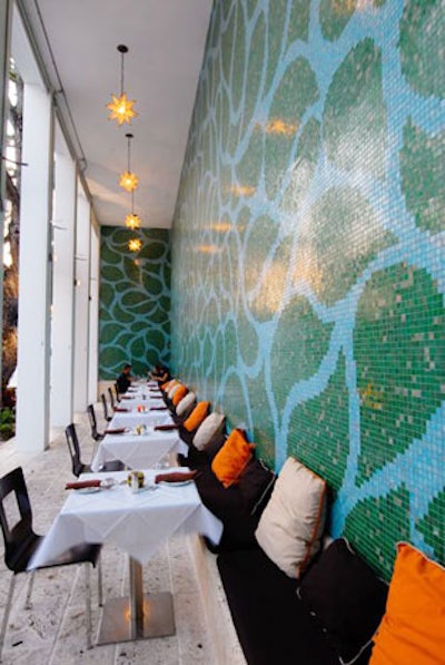 MaiTardi's expansive patio has seating for 80, with some tables along a mosaic tile wall.