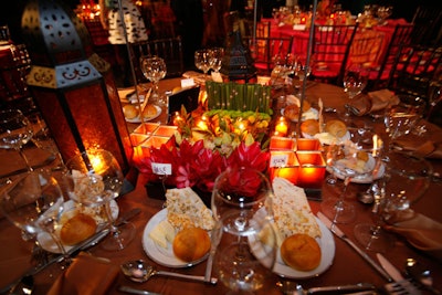 For the dinner tables, Ronsley Special Events created three styles of centerpieces; one design incorporated Moroccan lamps, golden cymbidium orchids, and bronze lamour linens.